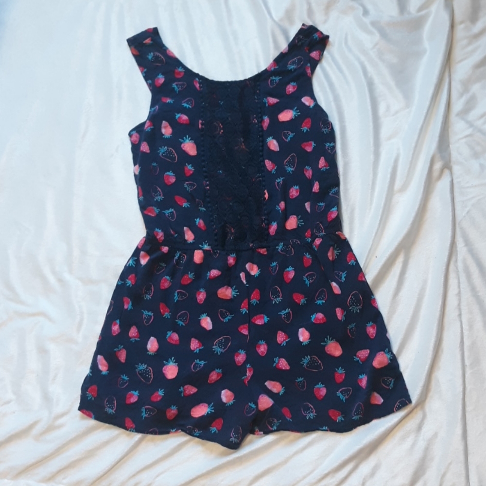 A dark blue strawberry lace romper